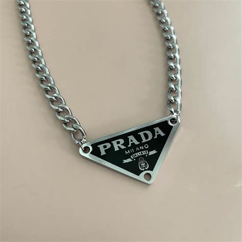 prada triangle necklace.